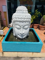 Big Buddha white head in large turquoise trough fountain